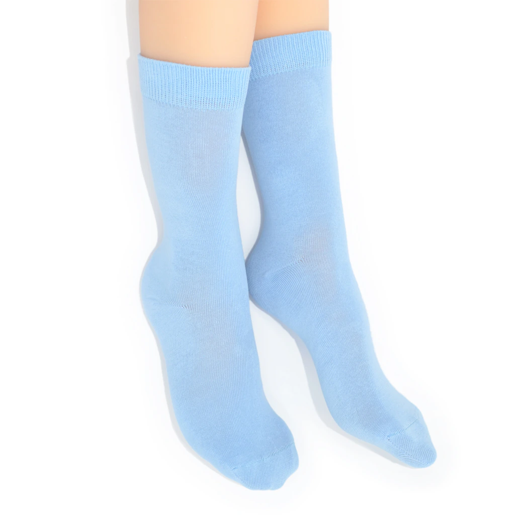Legs modelling light blue socks on a white background