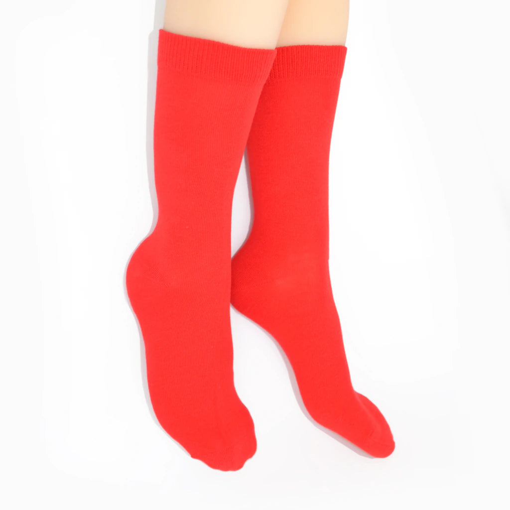 Legs modelling red socks on a white background