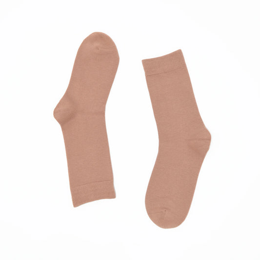 Pair of beige socks on a white background