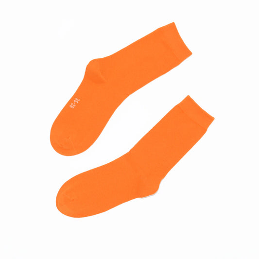 Two orange socks on a white background
