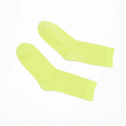 Pair of chartreuse socks on a white background