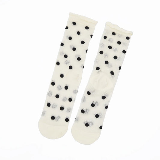 A pair of off-white sheer socks with black and light gray polka dots, displayed against a plain white background.