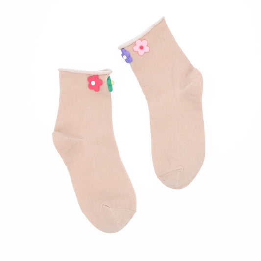 Beige socks with colorful flower designs on a white background