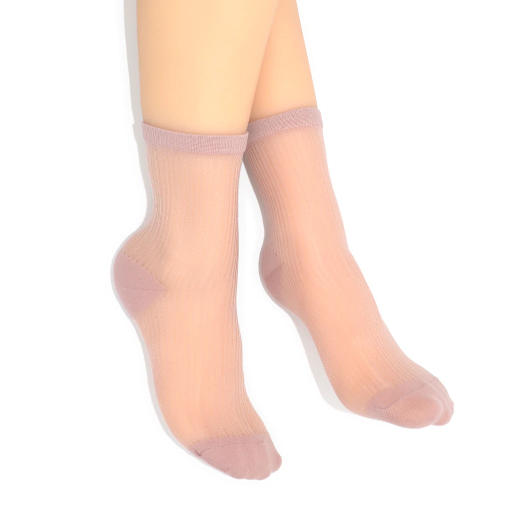 Sheer pink socks worn by a person on a white background