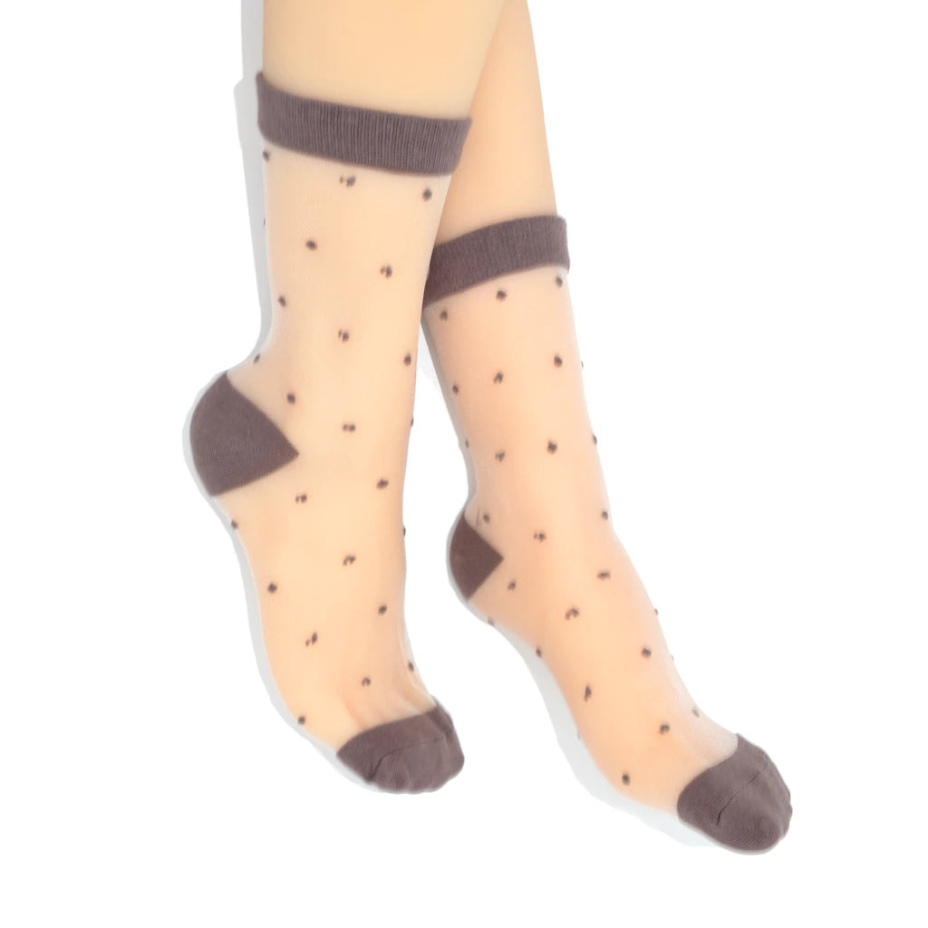 Sheer socks with brown polka dots and cuffs on a white background