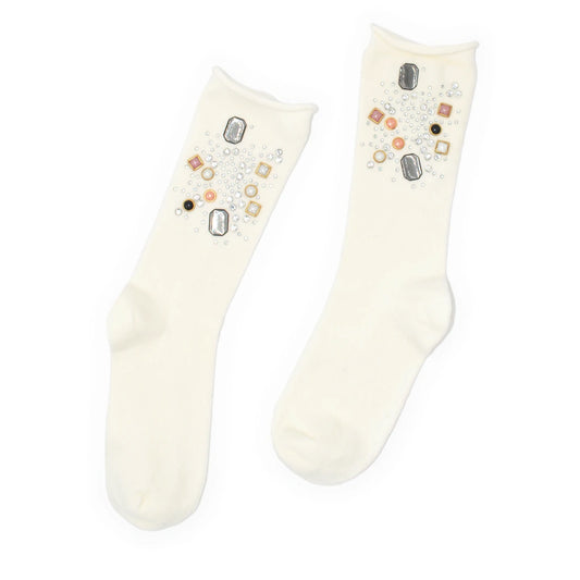 Pair of cream socks with decorative elements on a white background