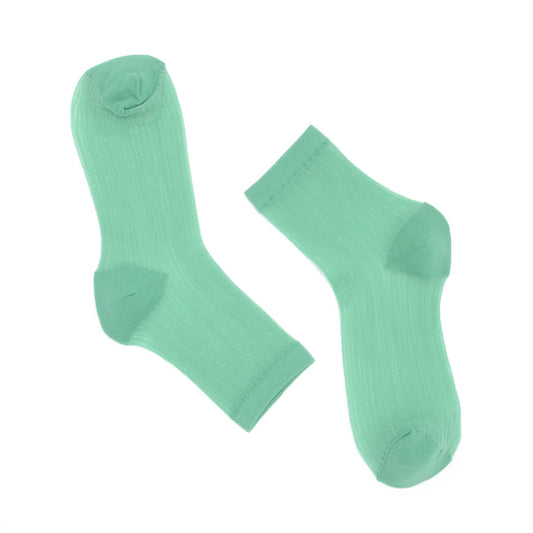Pair of light green socks on a white background