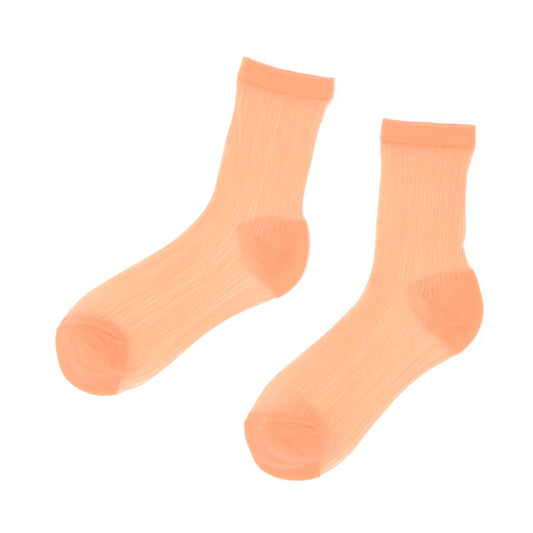 Pair of peach-colored socks on a white background