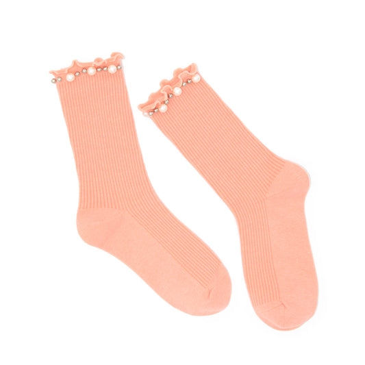 Pair of peach-colored socks with pearl embellishment on a white background