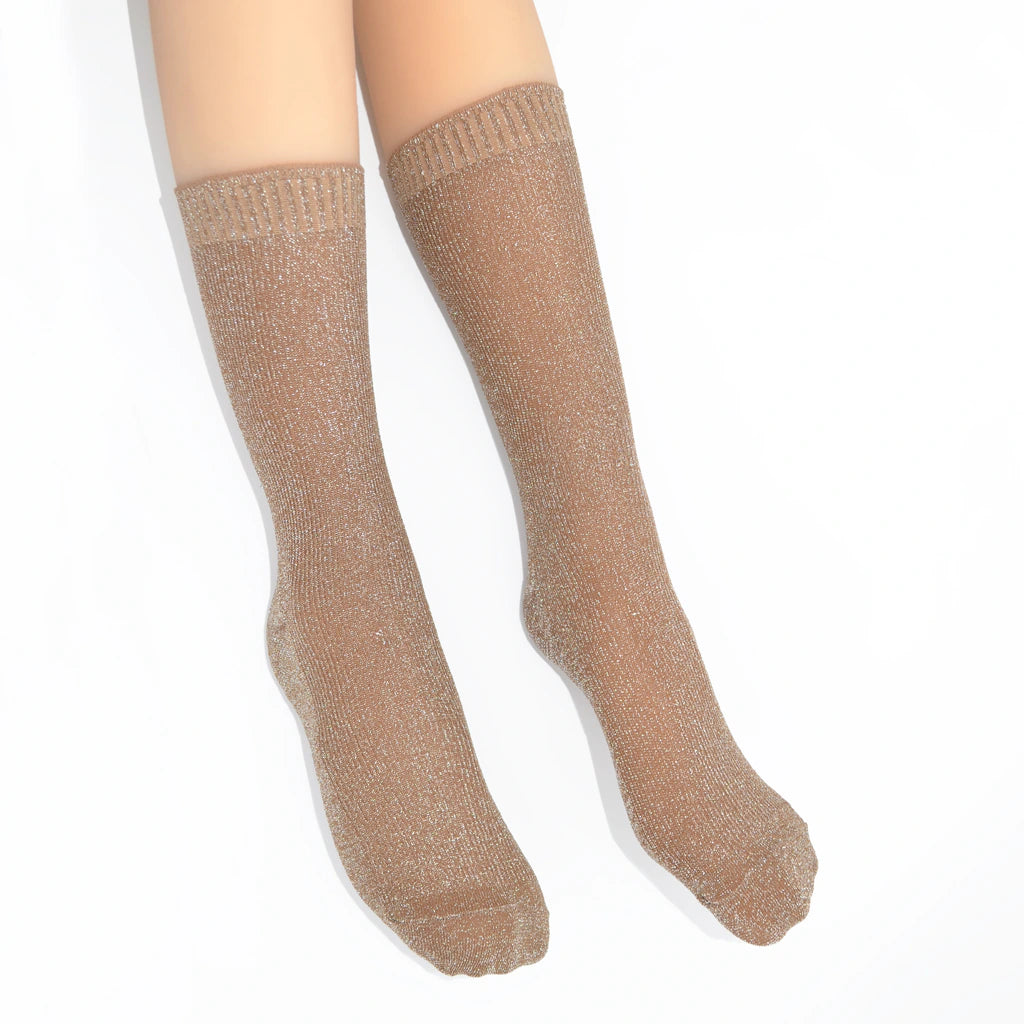 Beige socks worn by a person on a white background