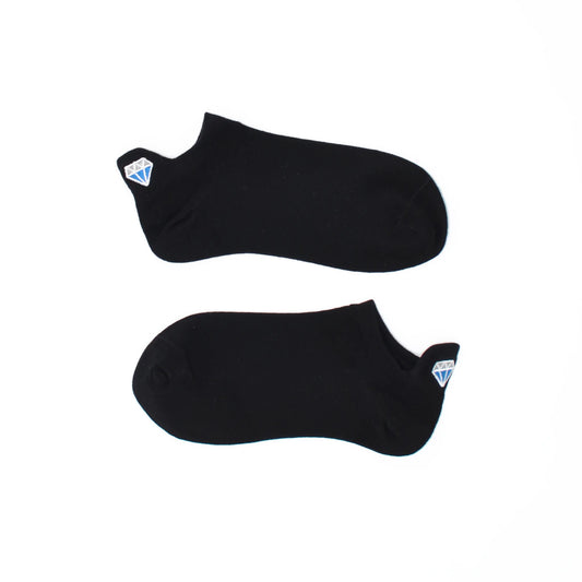 A pair of black no show socks with diamond-shaped embroidered tabs at the heel.
