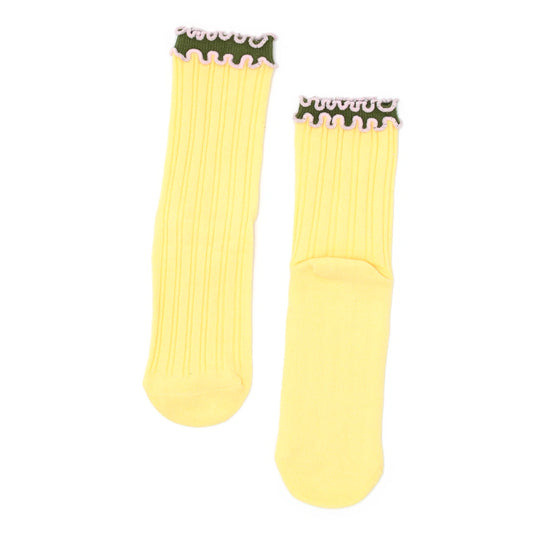 Pair of yellow socks with black and white trim on a white background