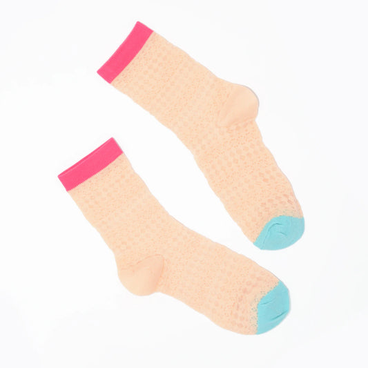 Pair of pink textured knit socks with pink and blue toes on a white background