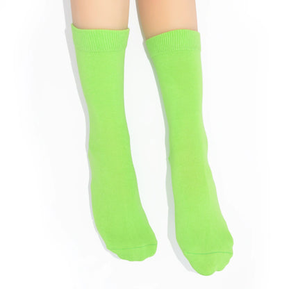 Legs modelling bright green socks on a white background