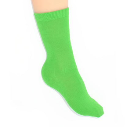 Leg modelling green socks on a white background