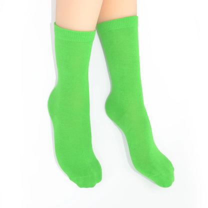 Legs modelling green socks on a white background