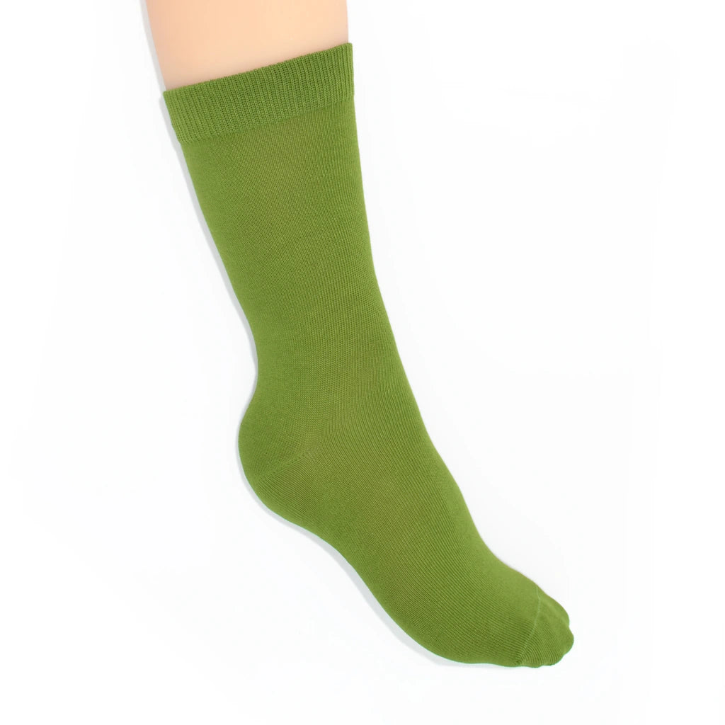 Leg modelling green socks on a white background