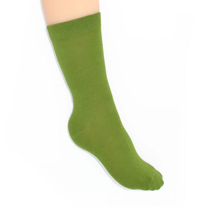 Leg modelling green socks on a white background