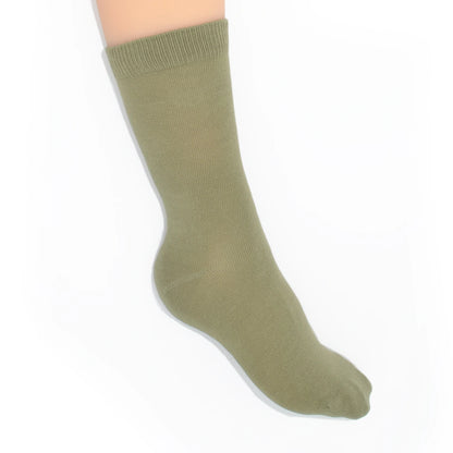 Leg modelling green socks on a white background