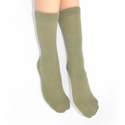 Legs modelling green socks on a white background