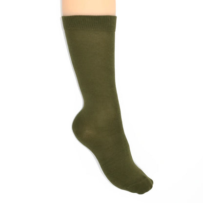 Leg modelling green socks on a white background