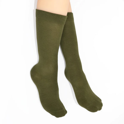 Legs modelling green socks on a white background