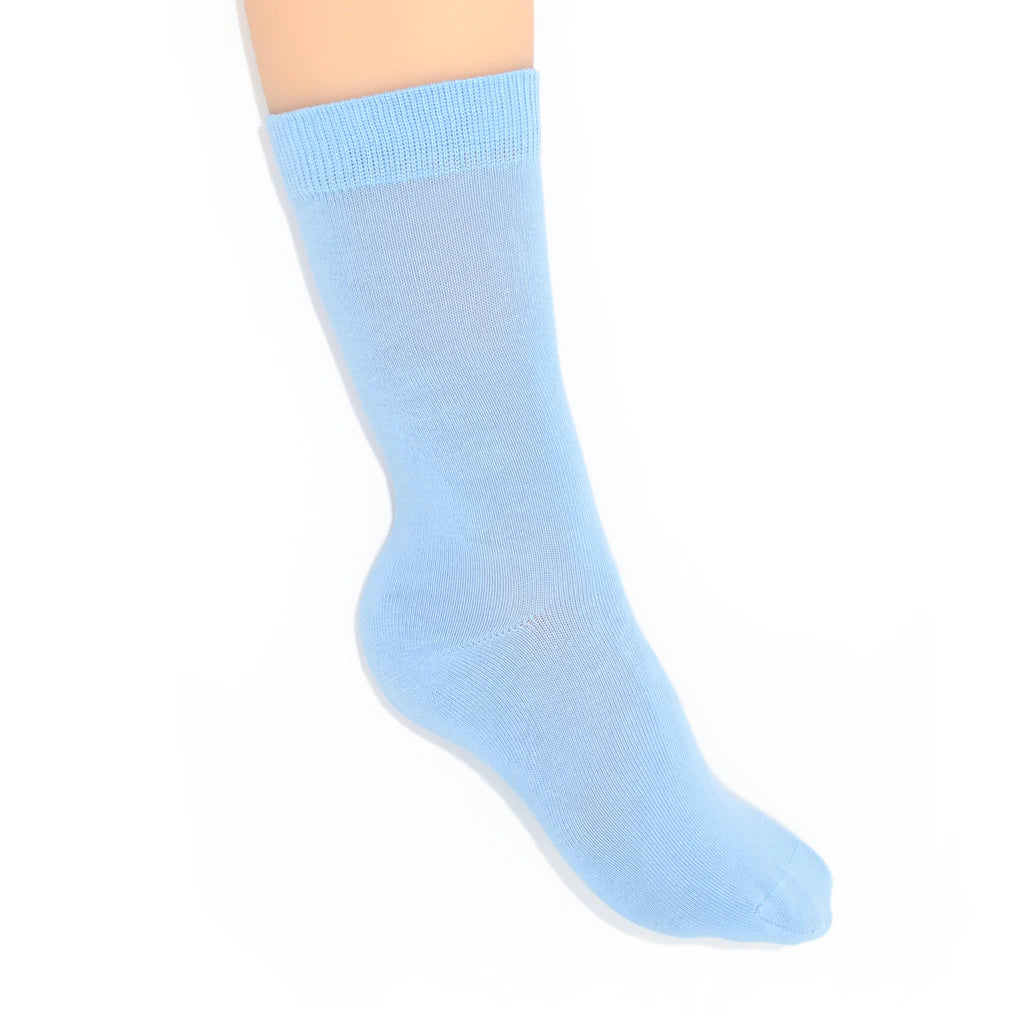 Leg modelling light blue socks on a white background