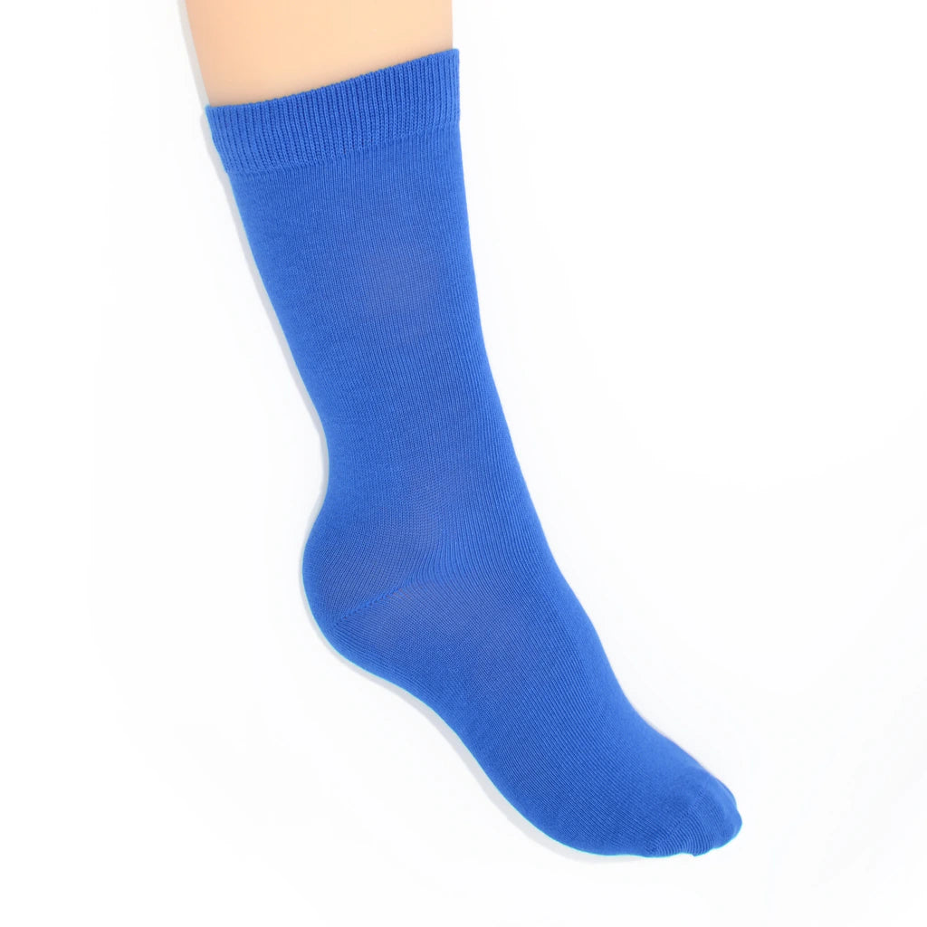 Leg modelling cobalt blue socks on a white background