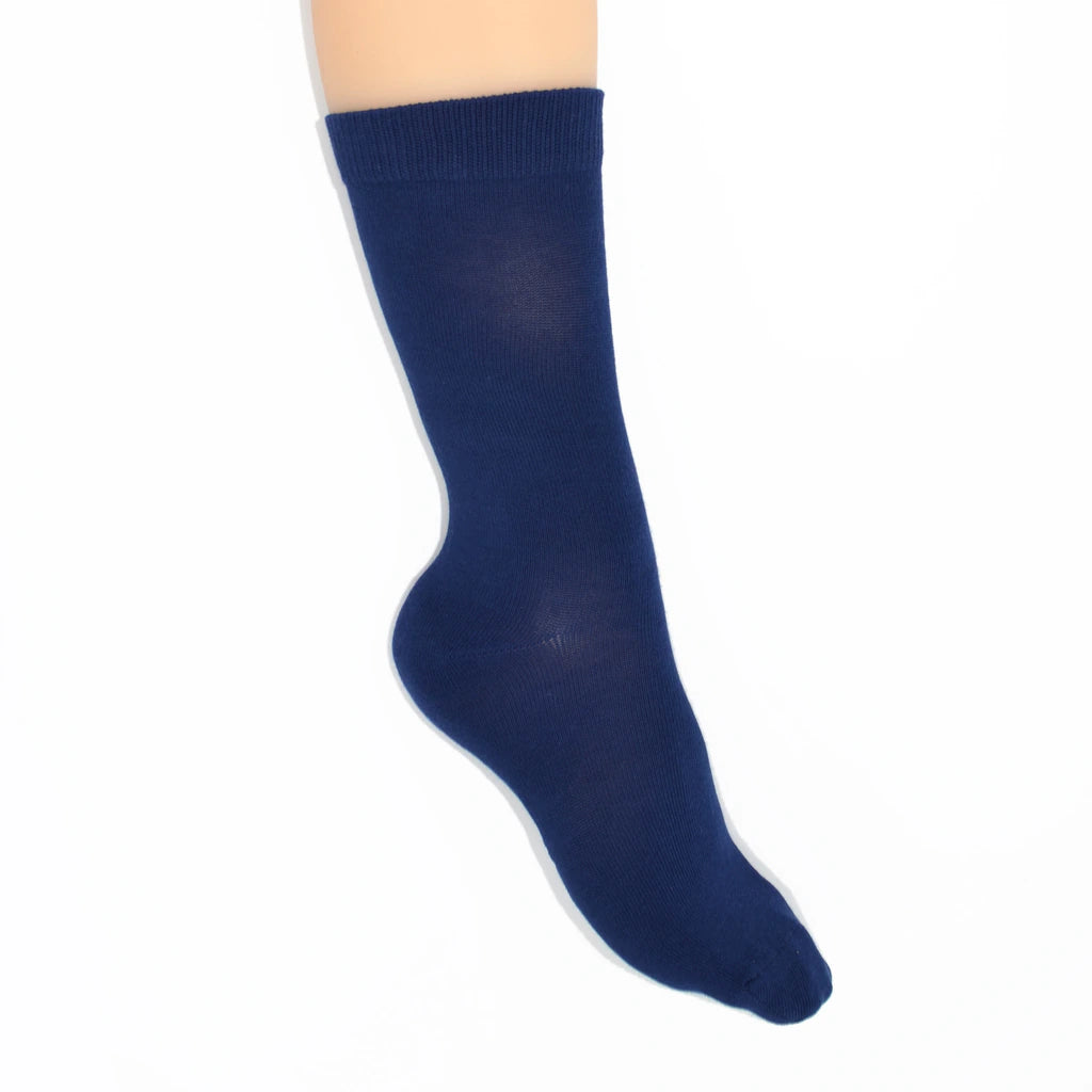 Leg modelling blue socks on a white background