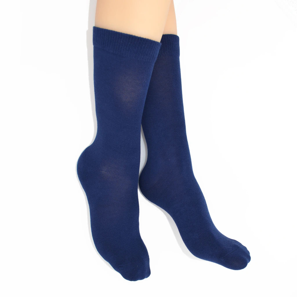 Legs modelling blue socks on a white background