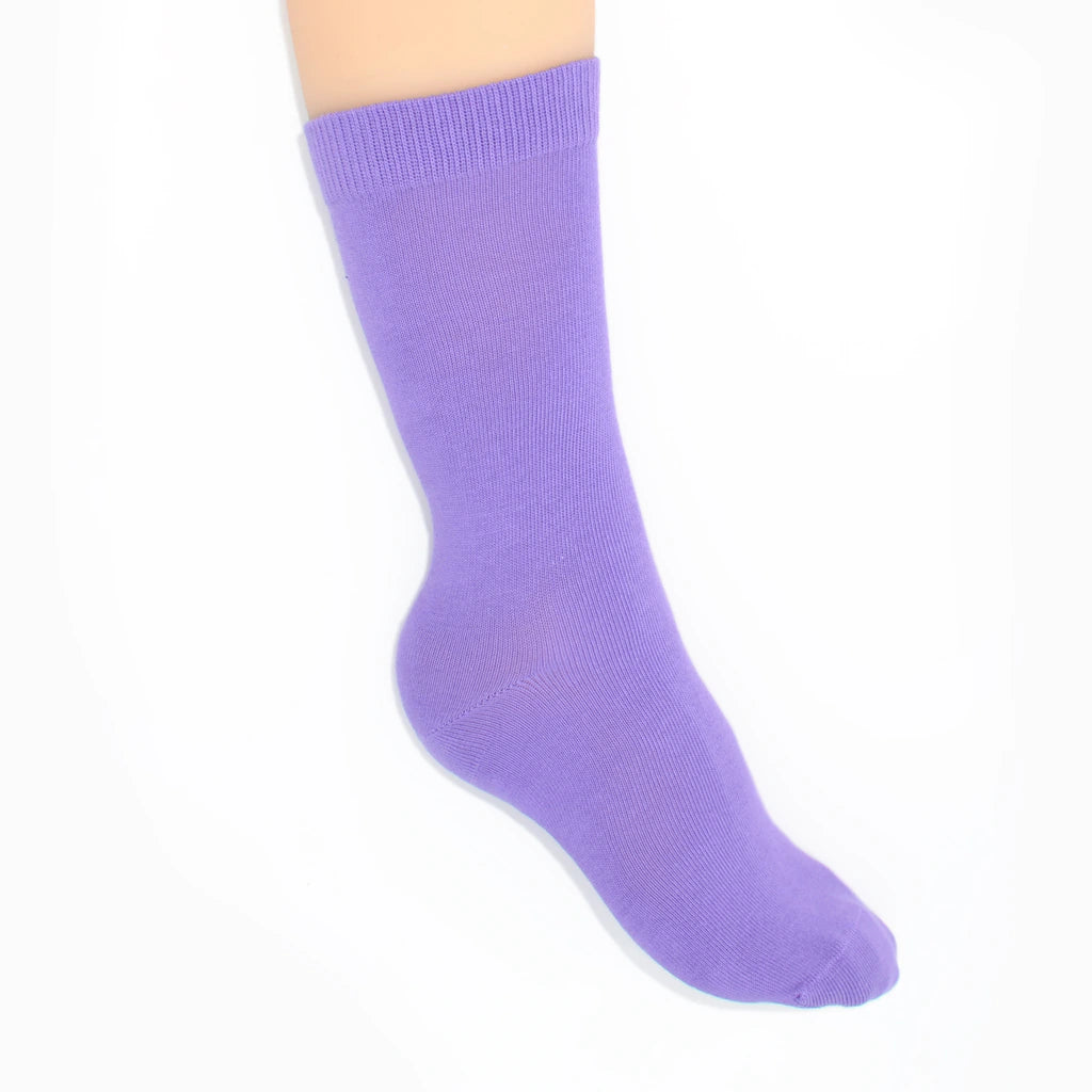 Leg modelling lavender socks on a white background