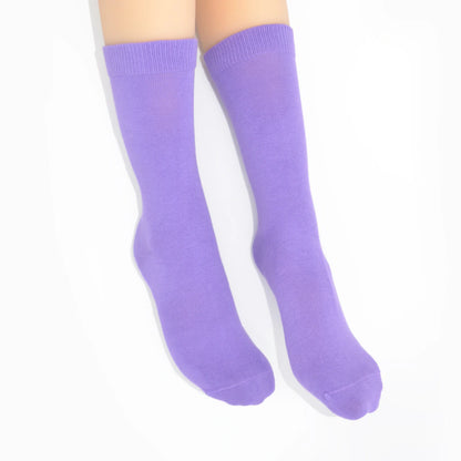 Legs modelling lavender socks on a white background