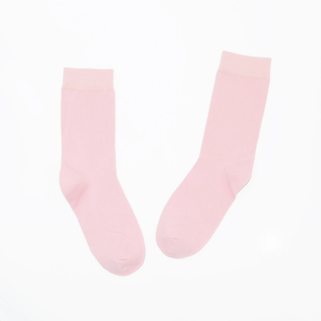 Pair of light pink socks on a white background