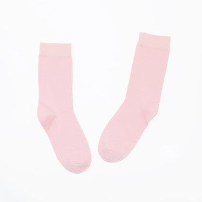Pair of light pink socks on a white background