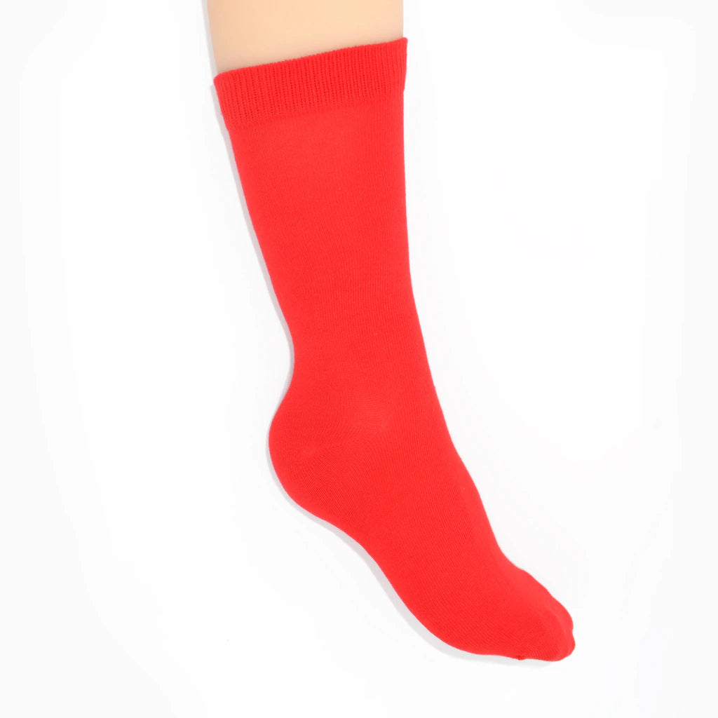 Leg modelling red socks on a white background