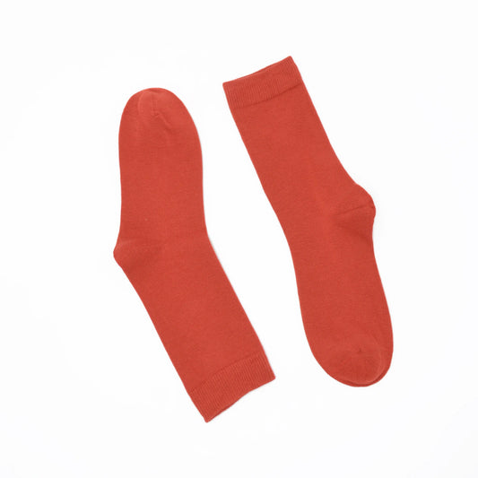 Pair of rust coloured socks on a white background