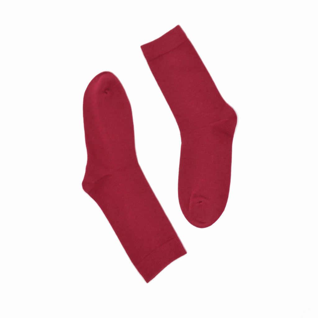 Pair of berry red socks on a white background