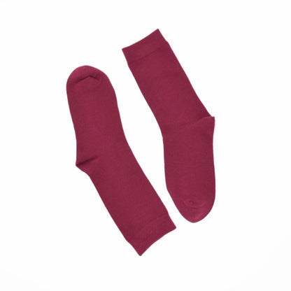 Pair of maroon socks on a white background