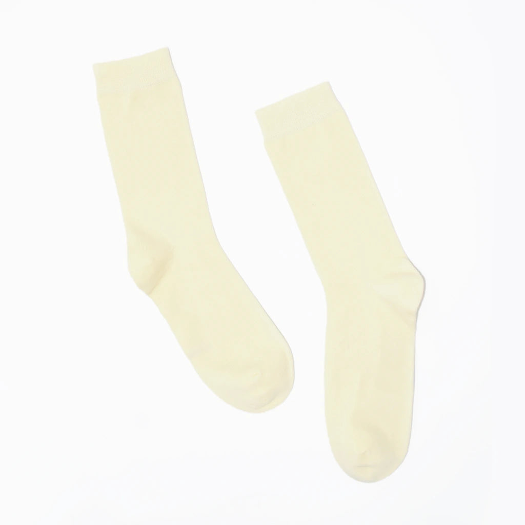 Pair of cream-colored socks on a white background