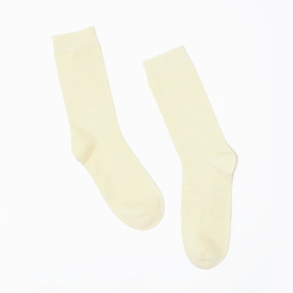 Pair of cream-colored socks on a white background
