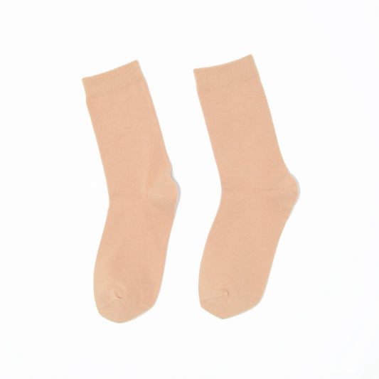 Pair of nude socks on a white background