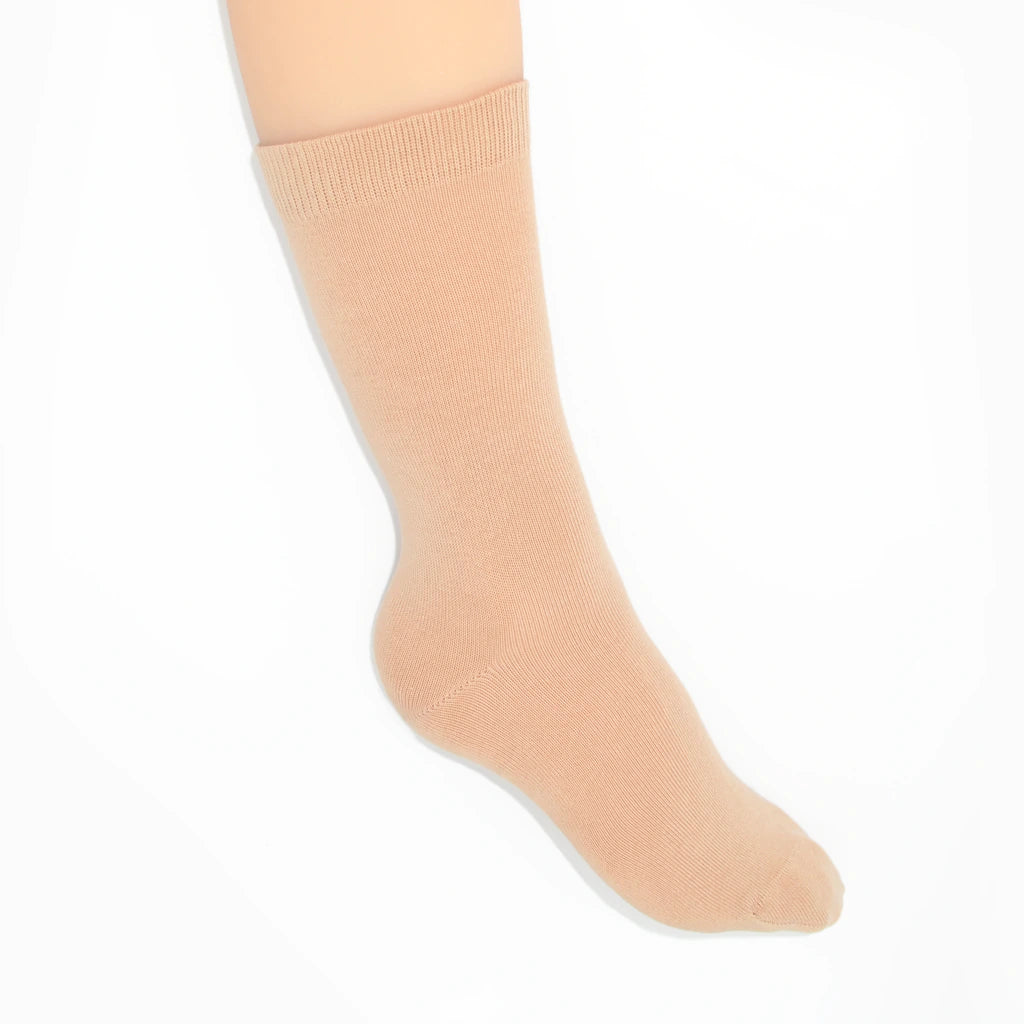 Leg modelling nude socks on a white background