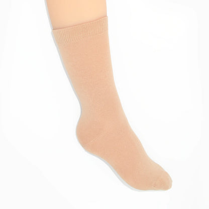 Leg modelling nude socks on a white background