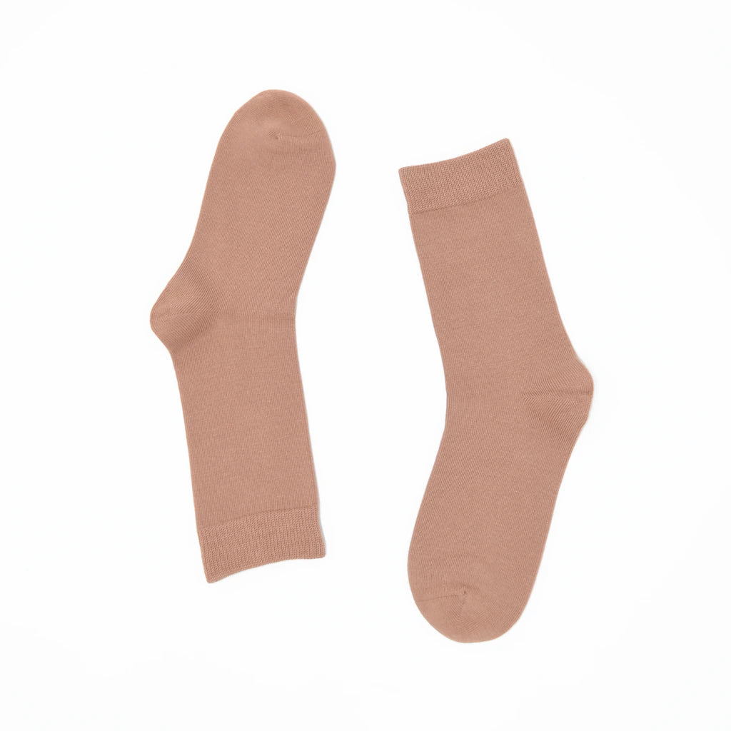 Pair of beige socks on a white background