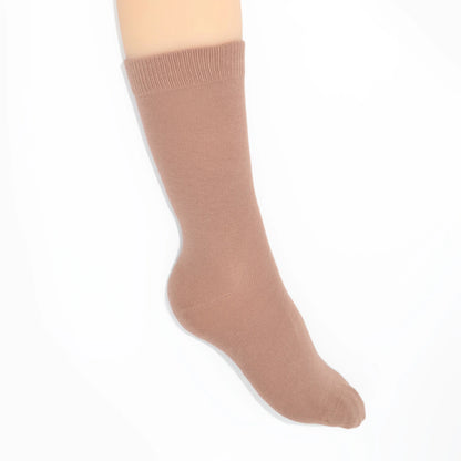 Leg modelling beige socks on a white background