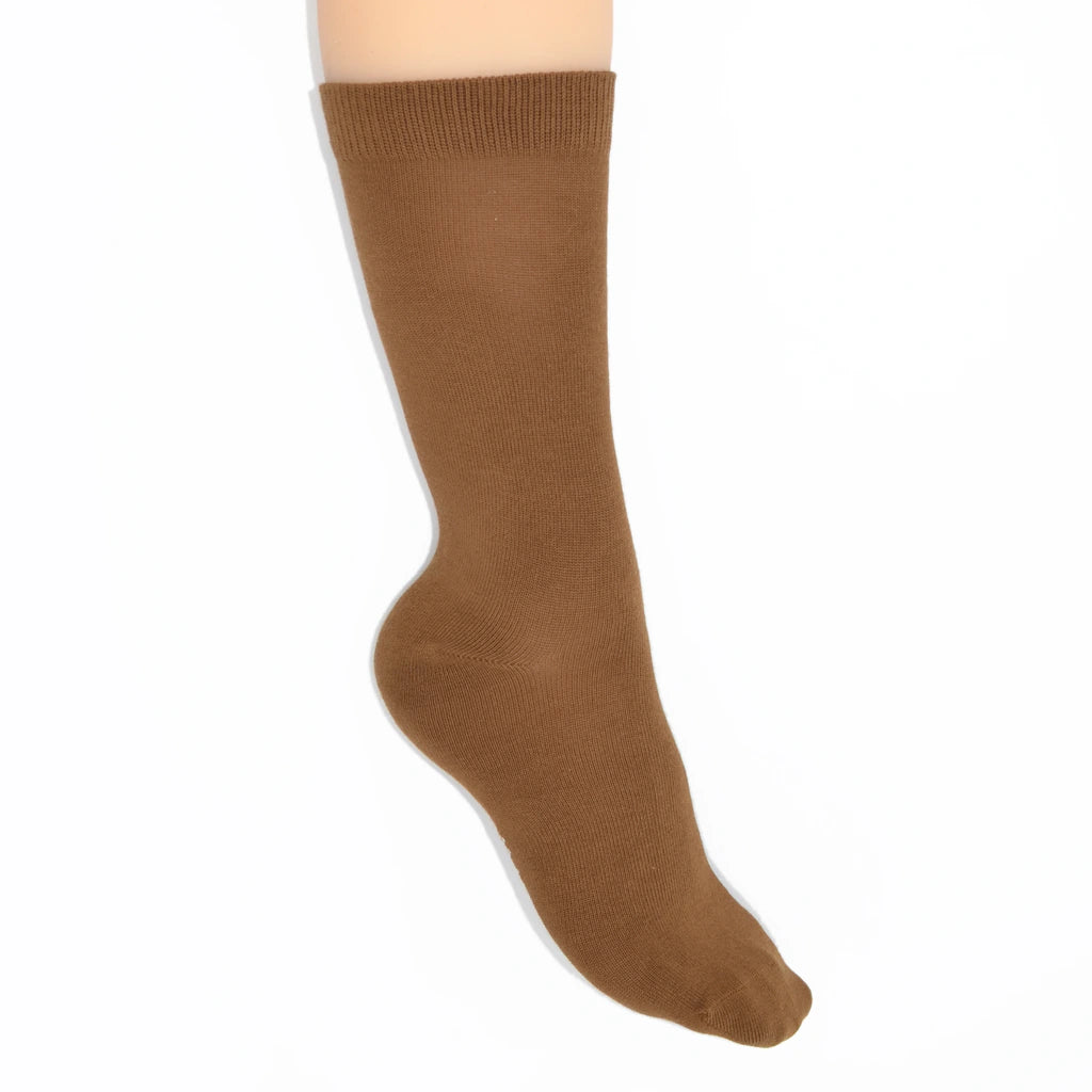 Leg modelling brown socks on a white background