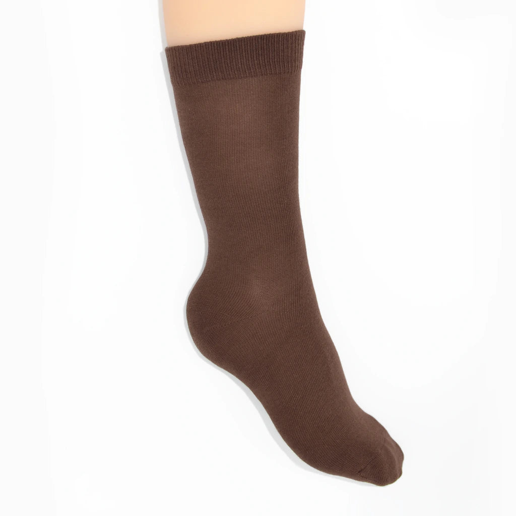 Leg modelling brown socks on a white background