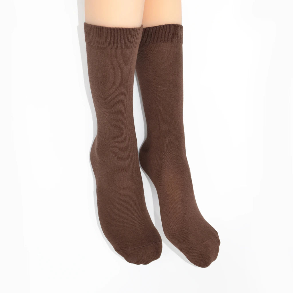 Legs modelling brown socks on a white background