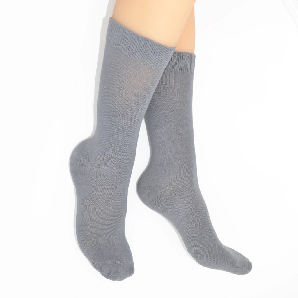 Legs modelling gray socks on a white background