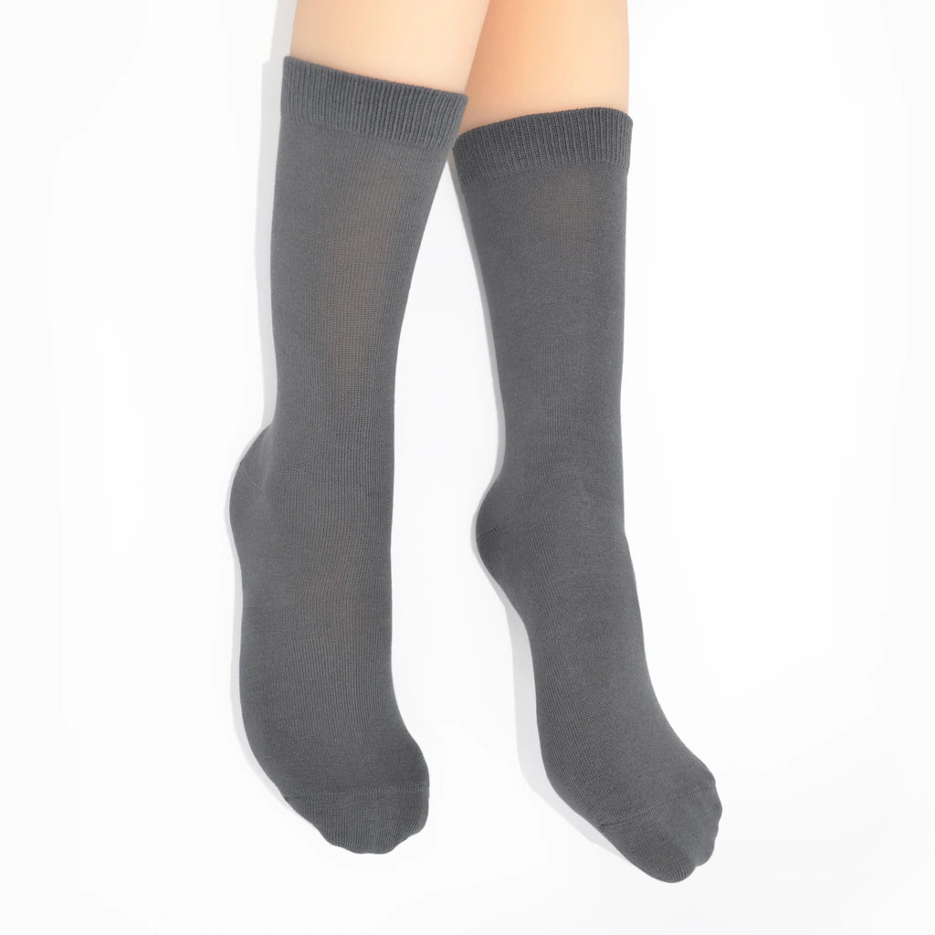 Legs modelling gray socks on a white background